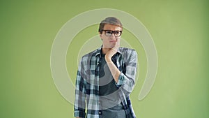 Portrait of young man suffering from toothache touching cheek with sad face