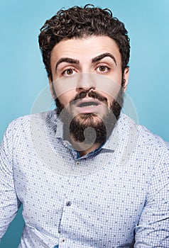 Portrait of a young man with a surprised face and open mouth