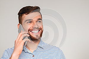 Portrait of young man talking on cellphone and smiling