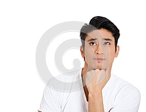 portrait of young man thinking daydreaming deeply about something with hand on chin looking upwards, isolated on white background