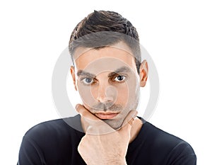 Portrait of young man touching his chin isolated on white background