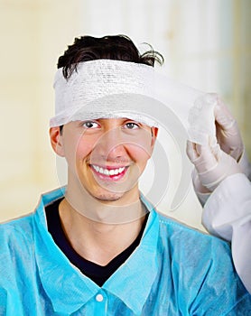 Portrait of a young man with trauma in his head and elastic bandaged around his head