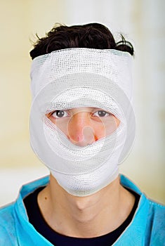 Portrait of a young man with trauma in his head and elastic bandaged around his head