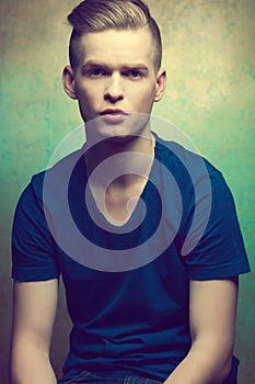 Portrait of a young man with very handsome face in blue casual t