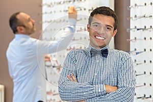Portrait young man wearing bow-tie in opticians