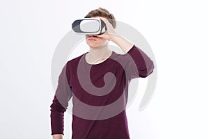 Portrait of young man wearing virtual reality goggles isolated on white background. Copy space and mock up. Smartphone and VR