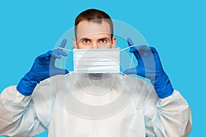 Portrait of young man wears protective mask gloves and protective suit against air pollution or transmissible infectious diseases