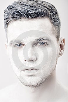 Portrait of young man with white face paint. Professional Fashion Makeup. fantasy art makeup