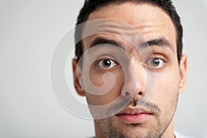 Portrait of young man with widely open eyes photo