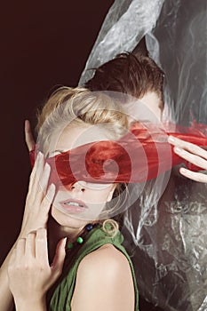 Portrait of young man and woman blindfolded