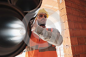 Portrait Of Young Man Working In Construction Site