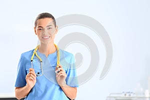 Portrait of young medical assistant with stethoscope in hospital. photo
