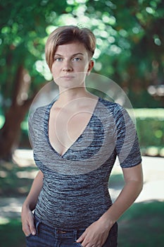 Portrait of young middle aged white caucasian girl woman with short hair stylish haircut in tshirt looking in camera