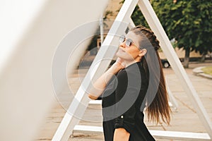 Portrait of young millennial woman on street. Hippie lifestyle. Happy smiling woman. Outdoors