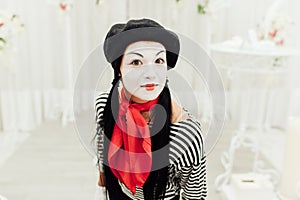 Portrait of young mime girl with black hat