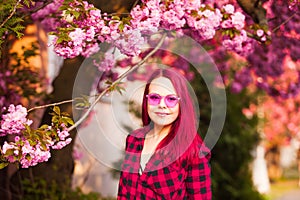 Portrait of young model with sakura bloom