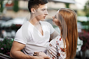 Portrait of young modern couple in love, posing outdoors in city street