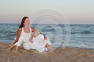 Portrait of a young mother and daughter on the seashore