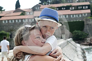 portrait of a young mother hugging her child on vacation at the