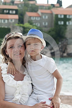 portrait of a young mother hugging her child on vacation at the