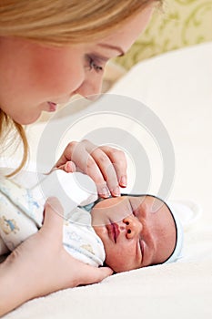 Portrait of young mother with newborn baby
