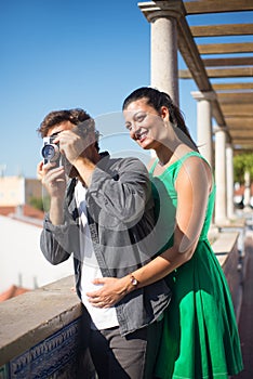 Portrait of young multiethnic couple travelling with camera