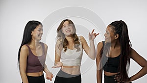 Portrait of young multiethnic models on white studio background close up. Group of three beautiful multiracial girls