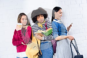 portrait of young multiracial students standing against white