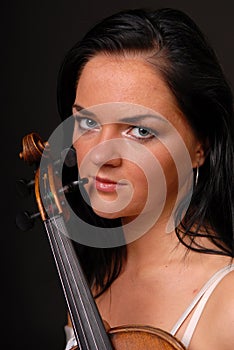 Portrait of young musician woman with violin