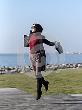 Portrait of young muslim woman jumping