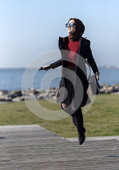 Portrait of young muslim woman jumping