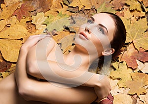 Portrait of young, natural and healthy woman over autumn background. Healthcare, spa, makeup and face lifting concept.