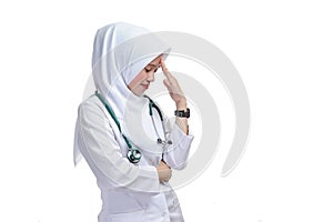 Portrait of young nurse with headache, side view