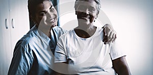 Portrait of young nurse with patient in nursing home