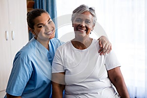 Portrait of young nurse with patient in nursing home