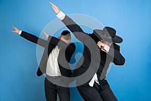 Portrait of a young orthodox jewish men  on blue studio background, meeting the Passover, dab