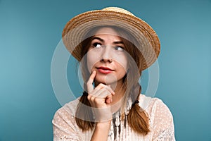 Portrait of a young pensive girl in summer hat isolatedway