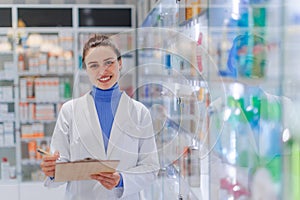 Portrait of young pharmacist in a pharmacy store.