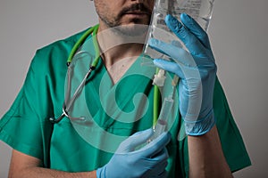 Portrait of a young physician using syringe
