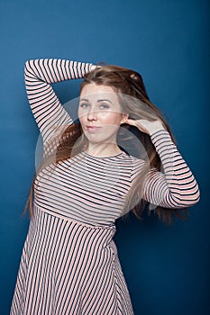 Portrait of  young plus size girl   in  dress on  blue background