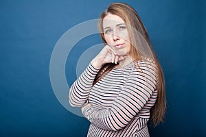 Portrait of  young plus size girl   in  dress on  blue background