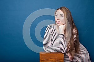 Portrait of  young plus size girl   in  dress on  blue background