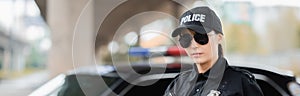 Portrait of young policewoman in sunglasses