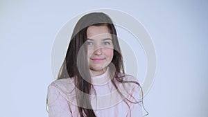 Portrait of young positive girl looking at camera