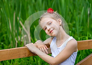 Portrait of young positive girl in park