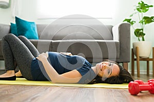 Portrait of a young pregnant woman resting from exercising