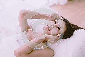 Portrait of young pretty asian woman lying down on bedroom,Sexy female and perfect skin,Close up face