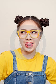 Portrait of young pretty Asian woman with two hair-buns and wear a jean dungaree