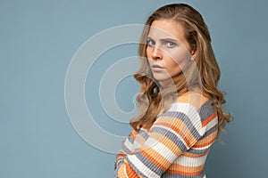 Portrait of young pretty beautiful angry grumpy dissatisfied blonde woman with sincere emotions wearing casual striped