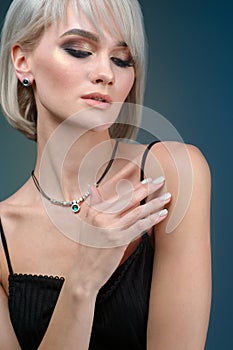 Portrait young pretty blond woman in luxury jewelry, lifestyle rich people concept, close up